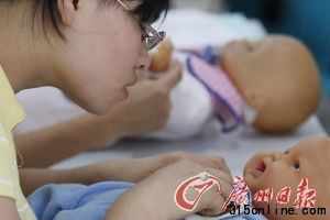 育婴师在上培训课,内容为抚触婴儿。 记者 倪黎祥 摄